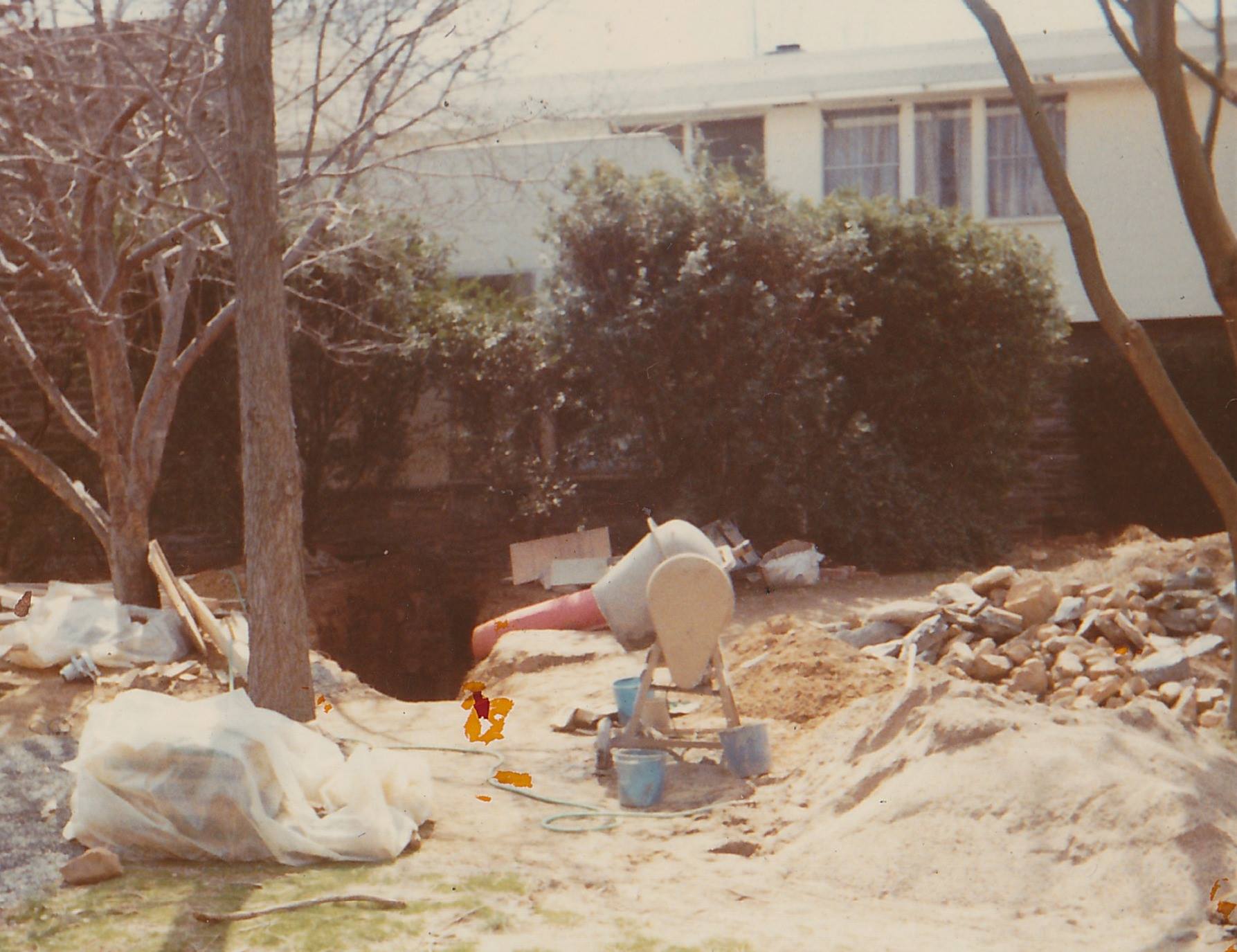 photo: Cement mixer beside ramp leading below the house